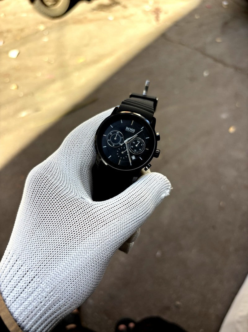 Hugo Boss full black chronograph model featuring a black dial and a matching black silicone strap