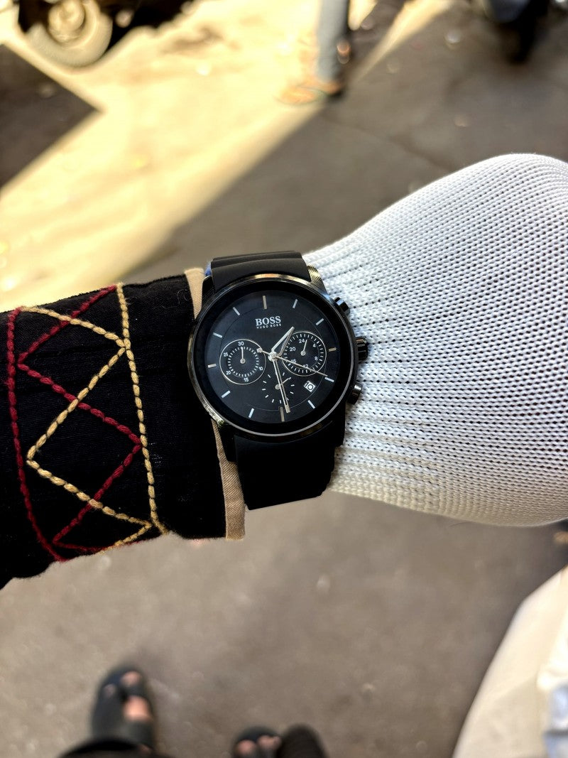 Hugo Boss full black chronograph model featuring a black dial and a matching black silicone strap